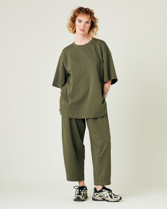 model wears olive huxley jersey trousers