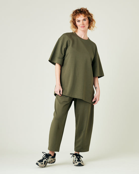 model wears olive huxley jersey trousers