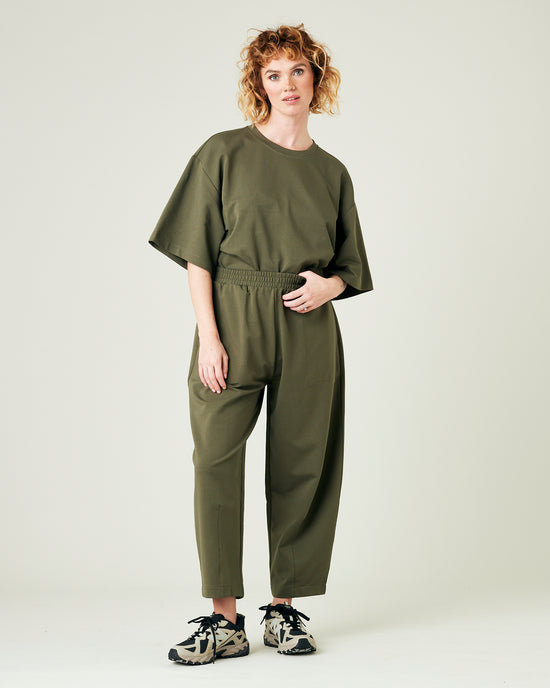 model wears olive huxley jersey trousers