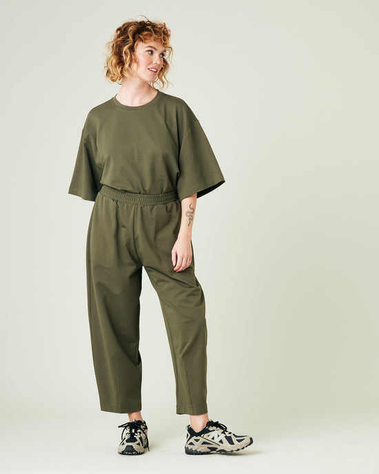 model wears olive huxley jersey trousers