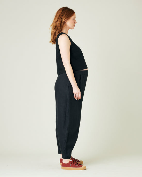 pregnant model wears black daisy linen trousers 