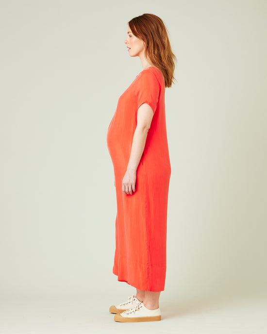 pregnant model wears coral celine jumpsuit