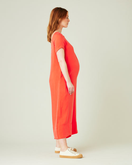 pregnant model wears coral celine jumpsuit