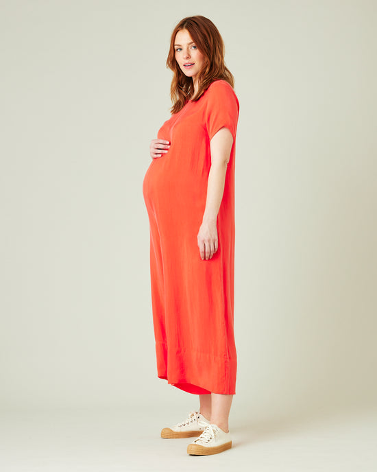 pregnant model wears coral celine jumpsuit