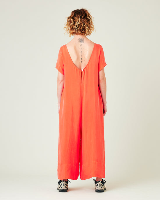 model wears coral celine jumpsuit