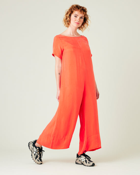 model wears coral celine jumpsuit