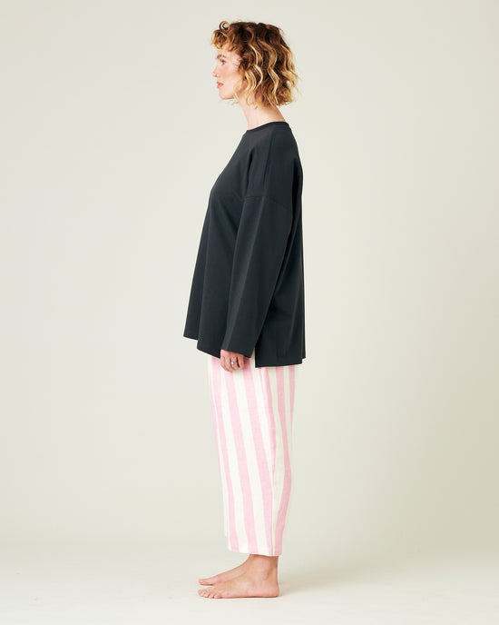 model wears pink and ecru stripe ultimate pj linen trousers