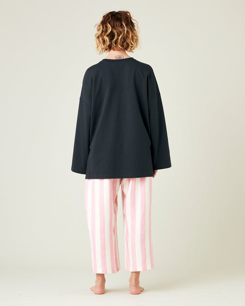 model wears pink and ecru stripe ultimate pj linen trousers