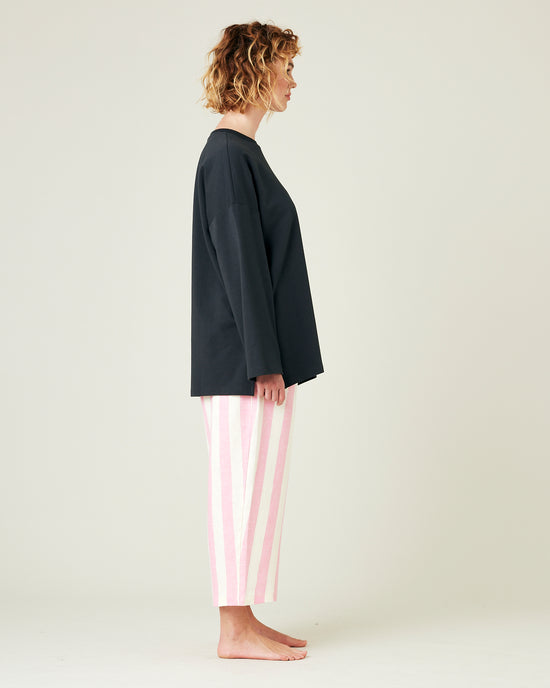 model wears pink and ecru stripe ultimate pj linen trousers