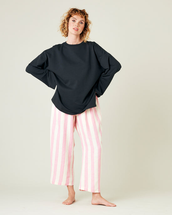 model wears pink and ecru stripe ultimate pj linen trousers