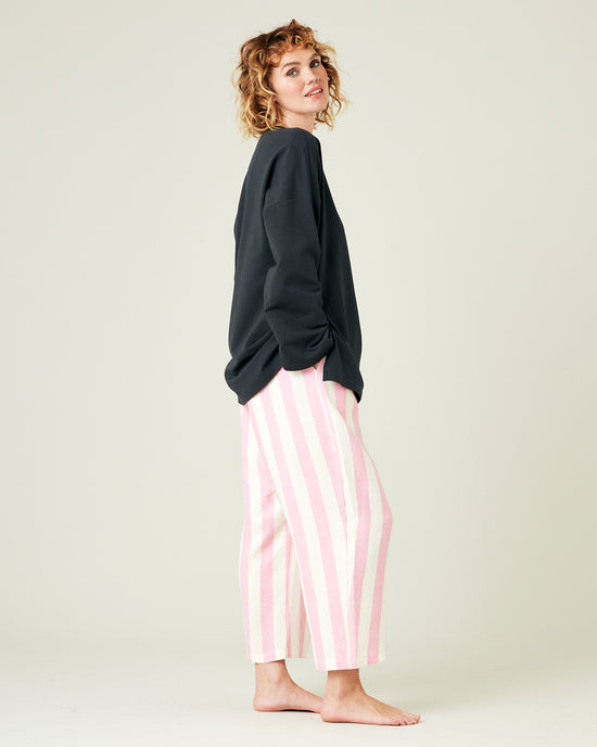 model wears pink and ecru stripe ultimate pj linen trousers