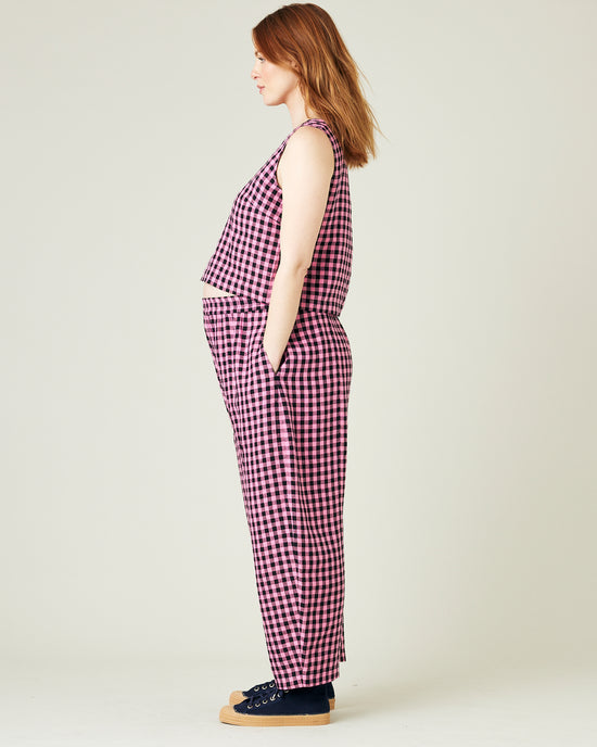 pregnant model wears pink and black gingham linen mabel trousers