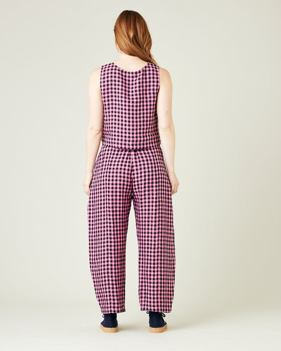 pregnant model wears pink and black gingham linen mabel trousers