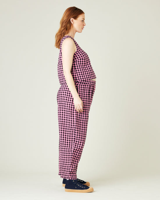 pregnant model wears pink and black gingham linen mabel trousers