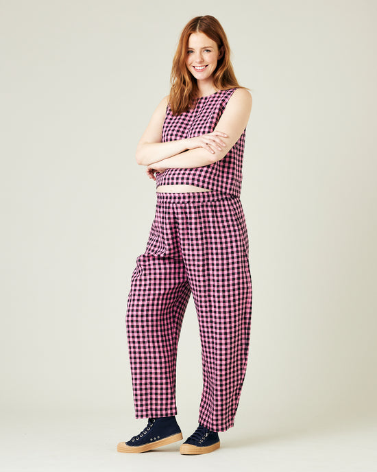 pregnant model wears pink and black gingham linen mabel trousers