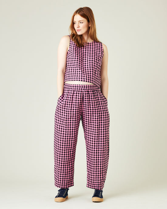 pregnant model wears pink and black gingham linen mabel trousers