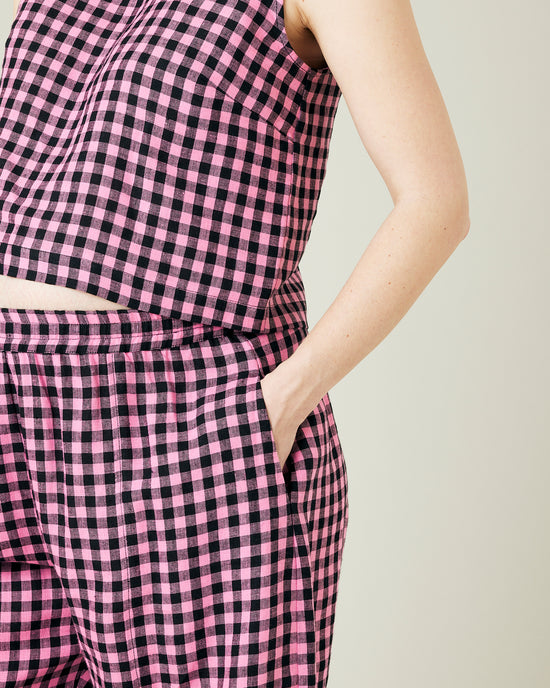 pregnant model wears pink and black gingham linen mabel trousers