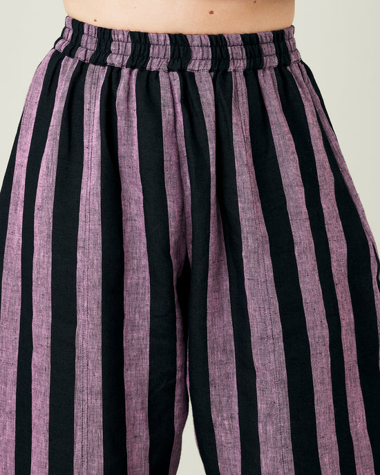 model wears pink and black stripe linen mabel trousers