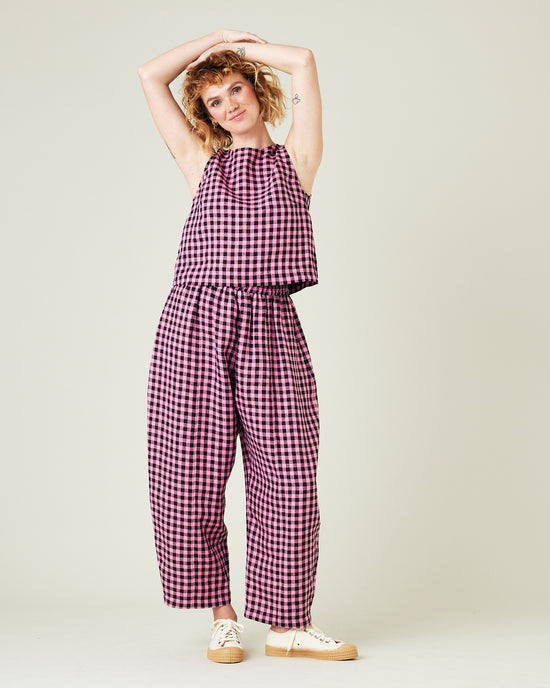 model wears pink and black gingham linen mabel trousers