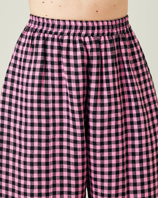 model wears pink and black gingham linen mabel trousers