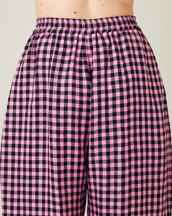 model wears pink and black gingham linen mabel trousers