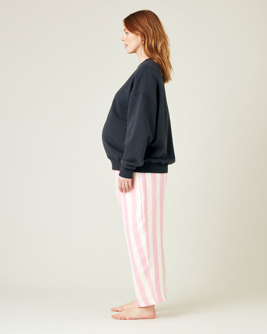 model wears pink and ecru stripe ultimate pj linen trousers