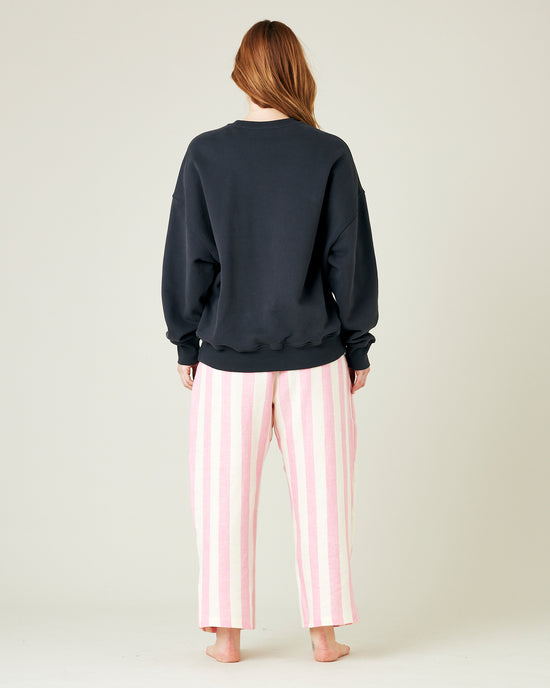 model wears pink and ecru stripe ultimate pj linen trousers