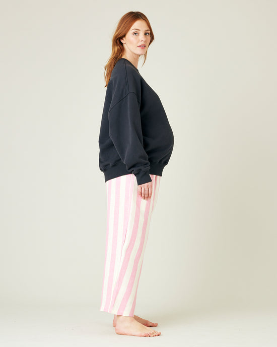 model wears pink and ecru stripe ultimate pj linen trousers