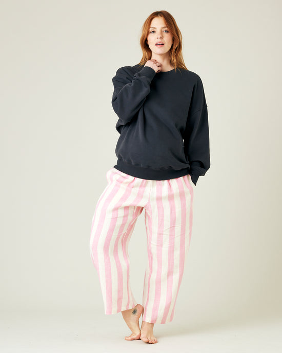 model wears pink and ecru stripe ultimate pj linen trousers