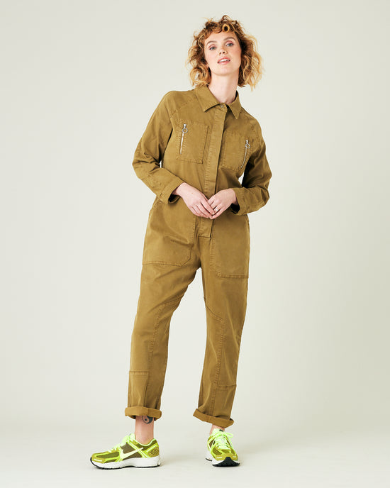 model wears nut green hallie jumpsuit