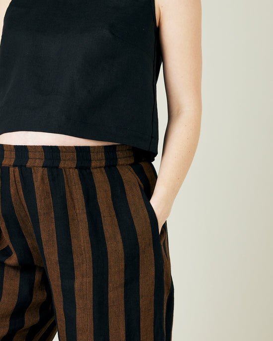 pregnant model wears rust stripe linen mabel trousers