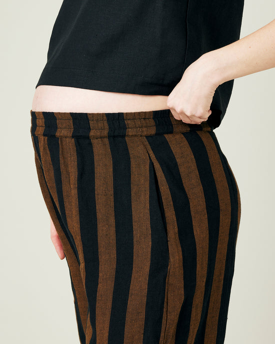 pregnant model wears rust stripe linen mabel trousers