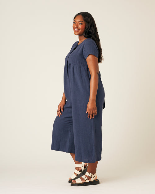 model wears navy linen sahara jumpsuit