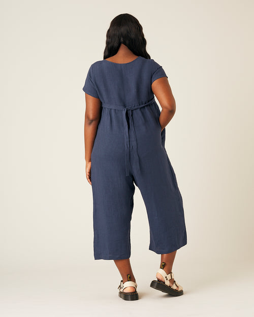 model wears navy linen sahara jumpsuit