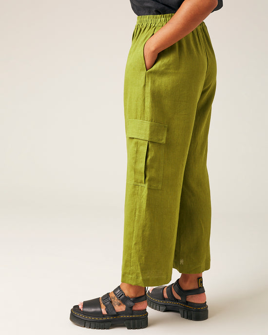 model wears pea pod linen trousers left