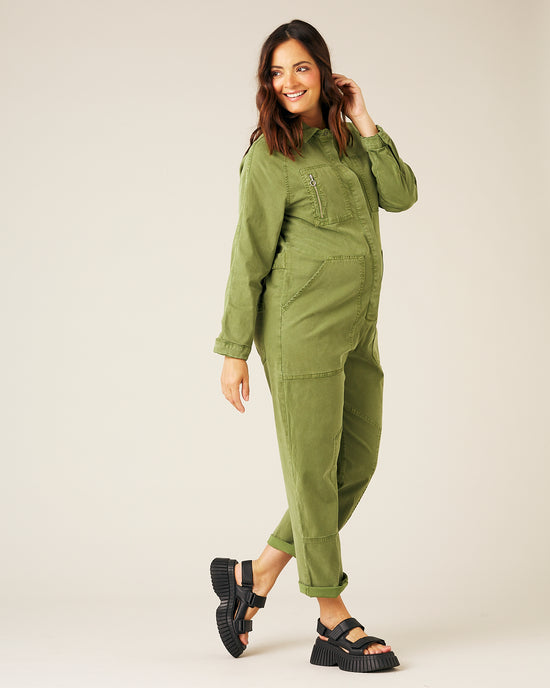 pregnant model wears moss green hallie jumpsuit