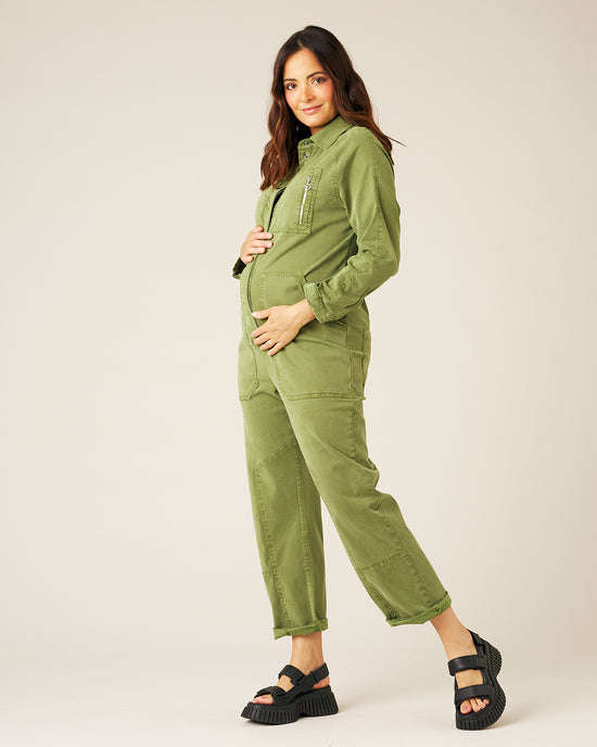 pregnant model wears moss green hallie jumpsuit