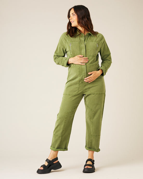 pregnant model wears moss green hallie jumpsuit