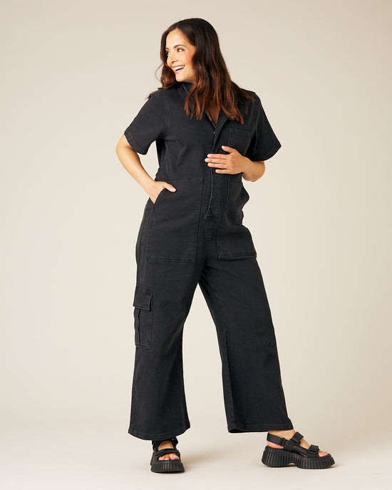 pregnant model wear black denim charlie jumpsuit