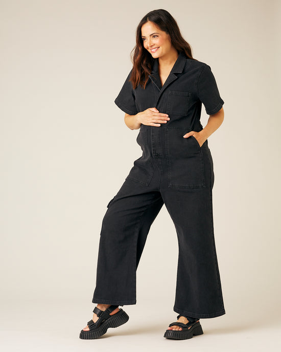 pregnant model wear black denim charlie jumpsuit