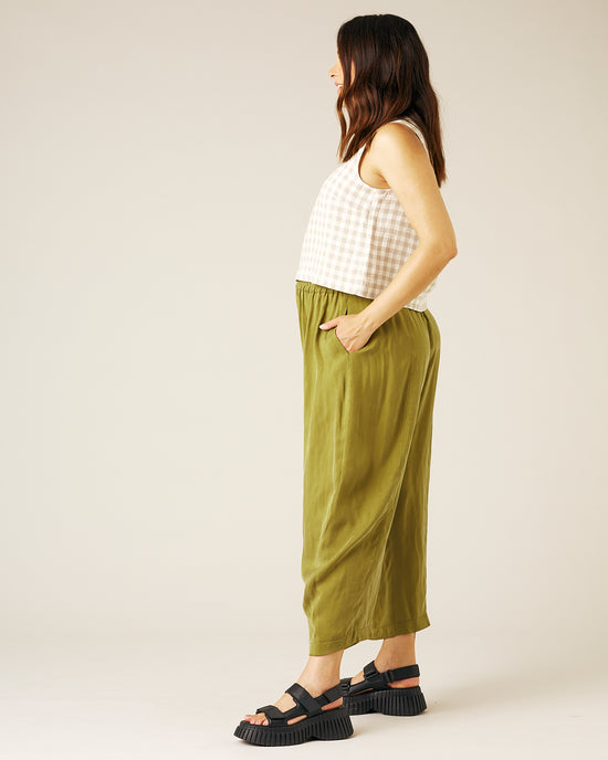 pregnant model wears olive cupro mabel trousers