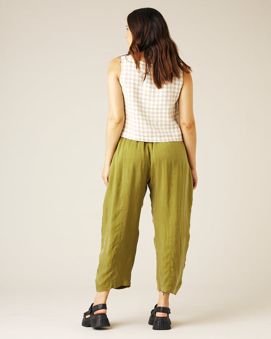 pregnant model wears olive cupro mabel trousers