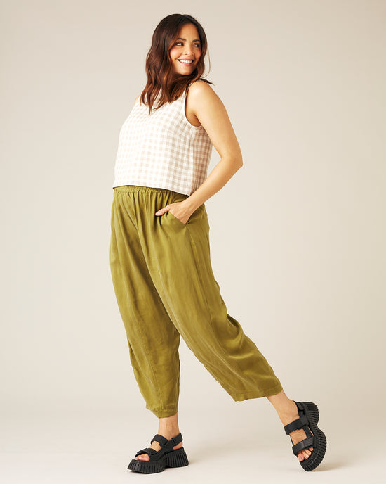 pregnant model wears olive cupro mabel trousers