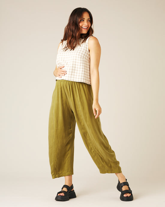 pregnant model wears olive cupro mabel trousers