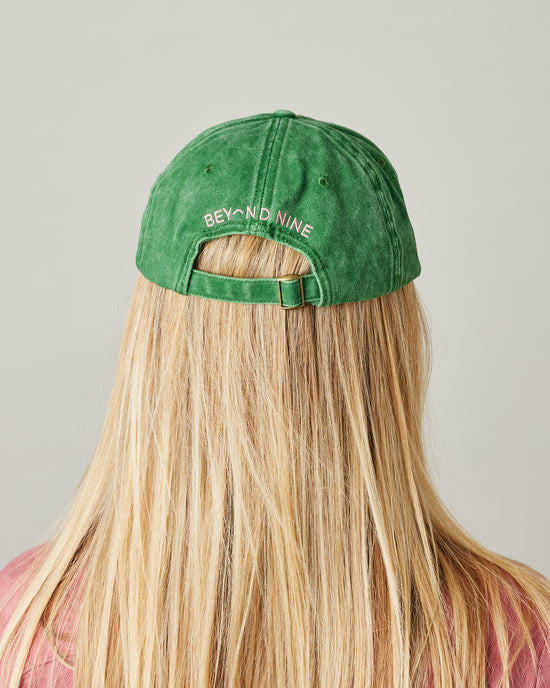  model wears green cord team mabel cap