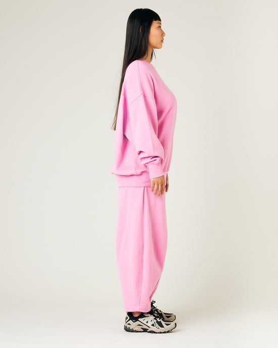 model wears pink daisy jersey trousers