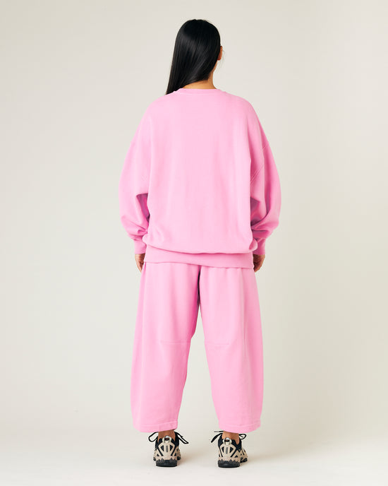 model wears pink daisy jersey trousers