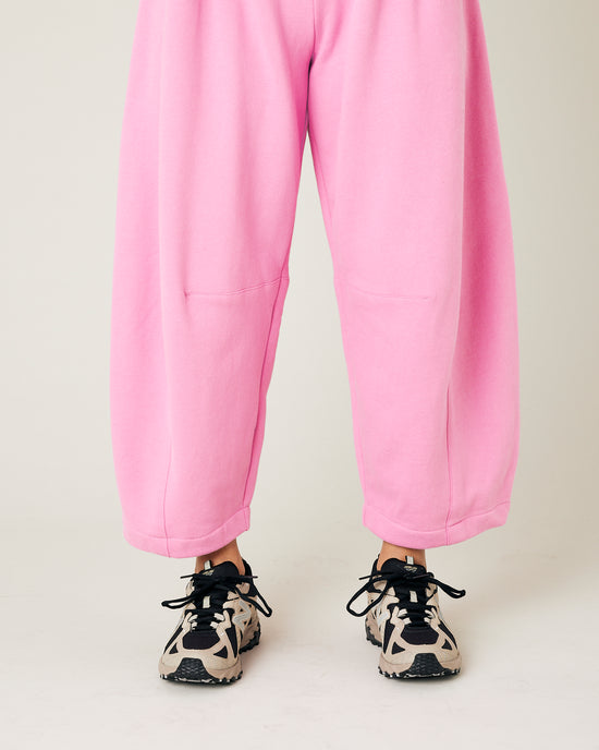 model wears pink daisy jersey trousers