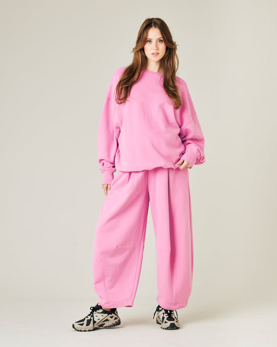 model wears pink daisy jersey trousers