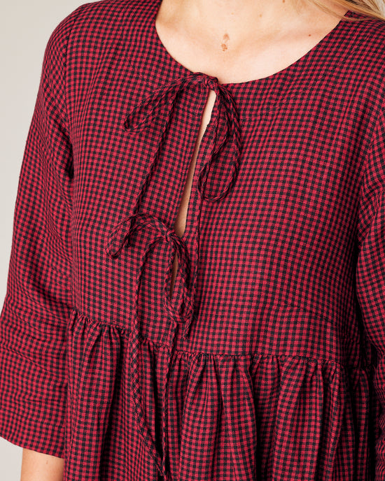 model wears red and black gingham linen willow dress